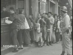 1947: CHINA: FOOD LINE: VS Chinese men & women standing on food line on street, various Chinese getting rice in sack, male pouring liquid (could be soup) into bottles for female. U.S. Economic Cooperation Administration (ECA) Instructional Video