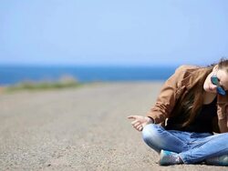 girl resting on the roadside Stock Footage