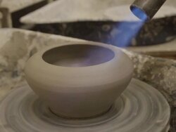 Clay pot being force dries using gas blow torch Stock Footage