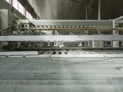 POV furniture pieces being fed through automated cutting machine Stock Footage
