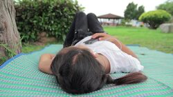 Girl lying and listen to music from smartphone,Dolly shot Stock Footage