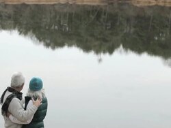 Loving mature couple by lake Stock Footage