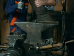 HD DOLLY: Blacksmith With Young Trainee Stock Footage