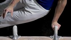 SLO MO Gymnast grabbing handles on pommel horse while performing Stock Footage