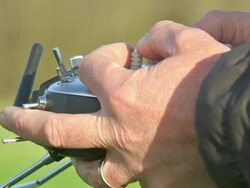 Remote-controlled camera drone being operated News Clip