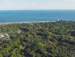 Bill Baggs State Park with Cape Florida Lighthouse from helicopter Stock Footage