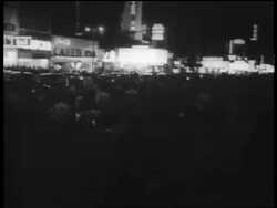 B/W Dec. 7 1941 crowd milling on city street at night after attack Pearl Harbor / newsreel Stock Footage