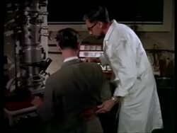 DNA models; scientists in lab with electron microscope. Crick & Watson?, Cambridge, England, UK 1960 Stock Footage