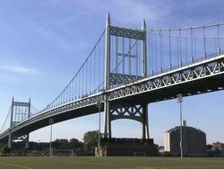 The Robert F. Kennedy Bridge - East River Span (formerly the Triborough Bridge) over a soccer field Stock Footage