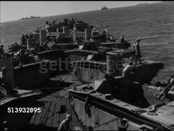 1944: ALLIED NAVY FLEET: VS Fleet of Allied naval ships at sea, various military vehicles, including tanks & trucks, & soldiers on deck of transport ships at sea, gunner turning artillery cannons, soldiers on deck. World War II, WWII Instructional Video