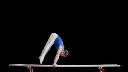SLO MO Gymnast swinging into hand stand on parallel bars Stock Footage