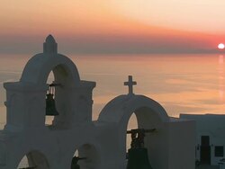 MS Shot of Sun setting and church bell at village Oia / Santorini, Cyclades, Greece Stock Footage