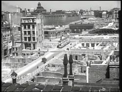 1945: ENGLAND RUINS: WS St Paul's Cathedral, ruins FG. HA WS London streets, destroyed buildings. LA WS Construction machine digging rubble, St Paul's Cathedral BG. MS Worker operating digging machine. Post-WWII Instructional Video