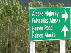 CU Shot of Roadside sign at Haines Junction, showing Alaska Highway, Haines road and Haines Alaska / Haines Junction, Yukon, Canada Stock Footage