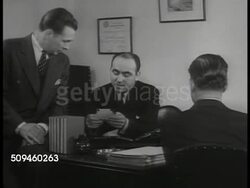 1938: SKIP TRACERS: DRAMATIZATION: Private Detective Daniel Eisenberg talking on telephone. SOUTHERN USA: LS Passenger train moving (R) on track in open scrub area w/ palm trees FG. Instructional Video