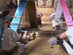 MS Shot of Four women wearing neck rings weaving on floor / Inle Lake, Shan State, Myanmar   Stock Footage