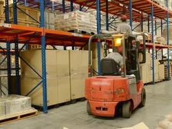 Worker Checking Inventory With Forklift Truck In Warehouse Stock Footage