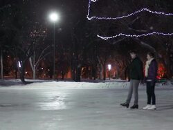 Couple has skating date on a snowy winter night. Stock Footage