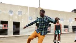 MS Group of friends watching man dance on rooftop of building Stock Footage