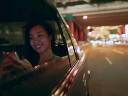TS Young Asian woman in a car at night, texting. Stock Footage