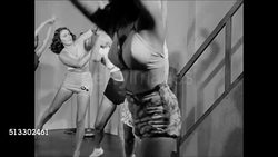 1945: EXERCISE CLASS: HD: Instructor Ms. Chester beating drum as female clients reach &amp; bend over swinging. Clients &amp; instructor going from exercising to dancing Cuban Rumba, WS all in circle doing Rhumba dance steps on dance floor. Instructional Video