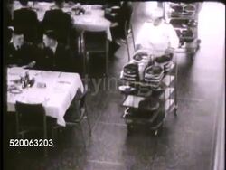 1963: UNITED STATES AIR FORCE ACADEMY: INT VS Waiters pushing carts out in dining hall (mess hall, Mitchell Hall), cadets sitting at tables, eating. Colorado, CO, doolies Instructional Video