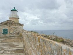 MS Shot of old Fort Paleo Frourio and lighthouse with clouds / Kerkyra, Corfu, Greece Stock Footage