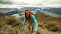 Hiker assists teammate on mountain top Stock Footage