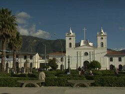 "View from street opposite Cathedral Church of Chachapoyas [LA IGLESIA CATEDRAL DE CHACHAPOYAS], blue skies and palm trees, Plaza De La Armas, Chachapoyas, Peru [PerÃƒÂº]" Stock Footage