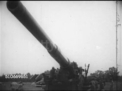 1952: OUR ATOMIC DEVELOPMENT: WS Soldiers hand cranking M65 Atomic Cannon ('Atomic Annie') barrel upward, barrel rising, BEHIND Automatic loading of weapon, soldier pulling firing cord, WS Artillery gun firing (280 mm, convential, or atomic warhead) Instructional Video