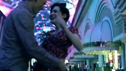 Young couple dance close under the colorful lights in downtown Las Vegas Stock Footage