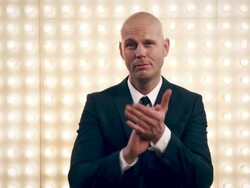 Man applauding in front of lightwall Stock Footage