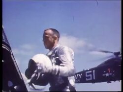 Astronaut Alan Shepard taking helmet from space capsule Stock Footage