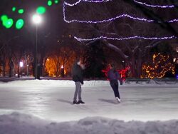 Couple has skating date on a winter evening. Stock Footage