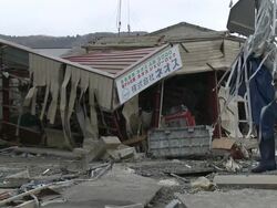 Destruction caused by tsunami after magnitude 9 Tohoku earthquake, north east Japan, March 2011. Building destroyed and surrounded by debris in Ishinomaki City port, Miyagi Prefecture Stock Footage