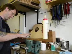 Craftsman 'Luthier' Nigel Forster making hand made Guitars Stock Footage