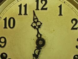 Timelapse 9 to 5 zoom out and track down across the face of an old clock. Working day. Stock Footage