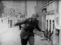 B/W 1961 East German guard jumps over barbed wire, drops gun + runs to truck / escaping East Berlin Stock Footage