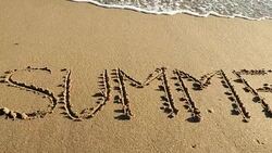 SUMMER written in sand Stock Footage