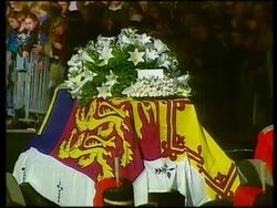 September 6, 1997 FILM MONTAGE MS Guards surrounding Princess Diana's casket during her funeral procession/ MS Casket/ CU White roses on casket with card saying 'Mummy'/ MS Procession passing royal family at Buckingham Palace/ London, England/ AUDIO Stock Footage