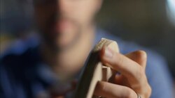 Craftsman carefully chisels intricate wooden frame Stock Footage