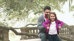 Little Hispanic girl sitting on father's shoulders Stock Footage