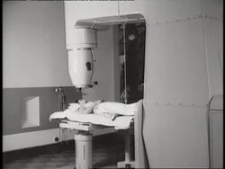 An x-ray machine revolves around a patient's leg. News Clip