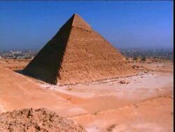 high angle wide shot tilt up of pyramid in desert / Giza, Egypt Stock Footage