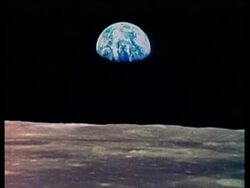 WA view of Earth from Apollo Saturn 17 on lunar surface, zoom in to CU of Earth partly in shadow Stock Footage