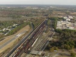 WS AERIAL View of railway tracks in city with wooded area / South Carolina, United States Stock Footage