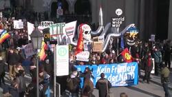Protesters marched through the center of Munich on Saturday protesting against NATO taking one of the leading roles in the conflict with Russia over Ukraine. The world's top diplomats have gathered at a security conference in the city. (Feb. 7 Instructional Video