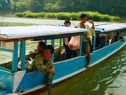 MS SLO MO Shot of small boat approaching river bank and man paying money of his trip / Muang Ngoi, Luang Prabang, Laos Stock Footage