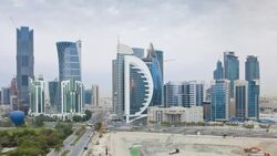 Hot air balloons lift up and over the skyline of Doha. Stock Footage