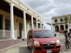 Trinidad Cuba cobblestone streets with people moving and relaxing in their lives Stock Footage